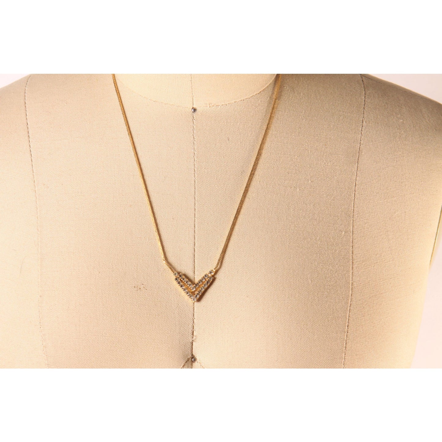 1970s Gold Tone Metal V Shape Pendant Rhinestone Faux Stone Necklace