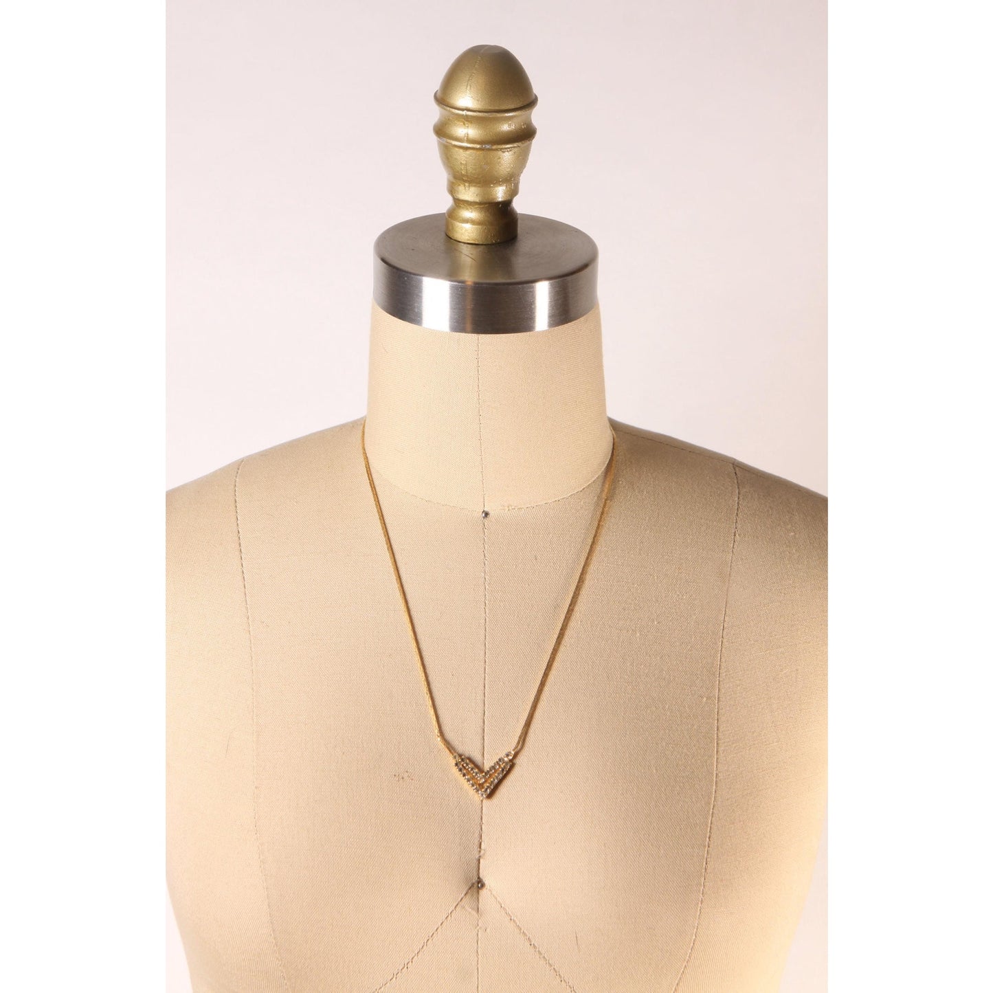 1970s Gold Tone Metal V Shape Pendant Rhinestone Faux Stone Necklace