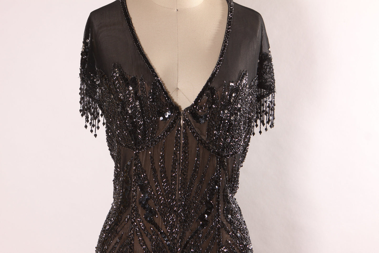 Late 1980s Early 1990s Black Sequin and Beaded Fringe Short Sleeve Flapper Style Sheer Nude Illusion Dress by Peak Evenings -M